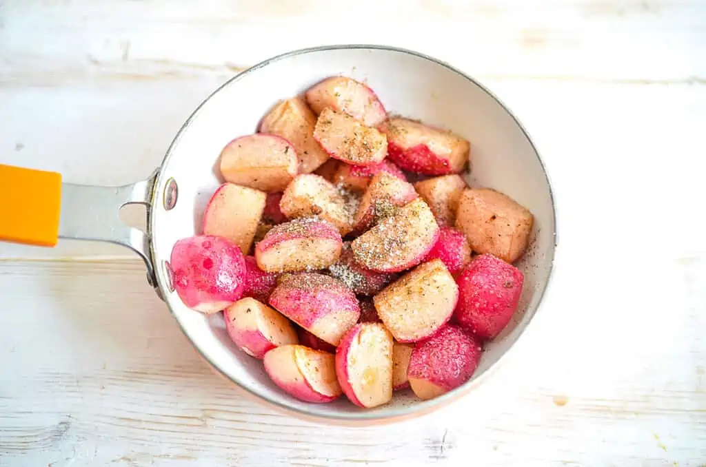 Seasoned radishes in a skillet.