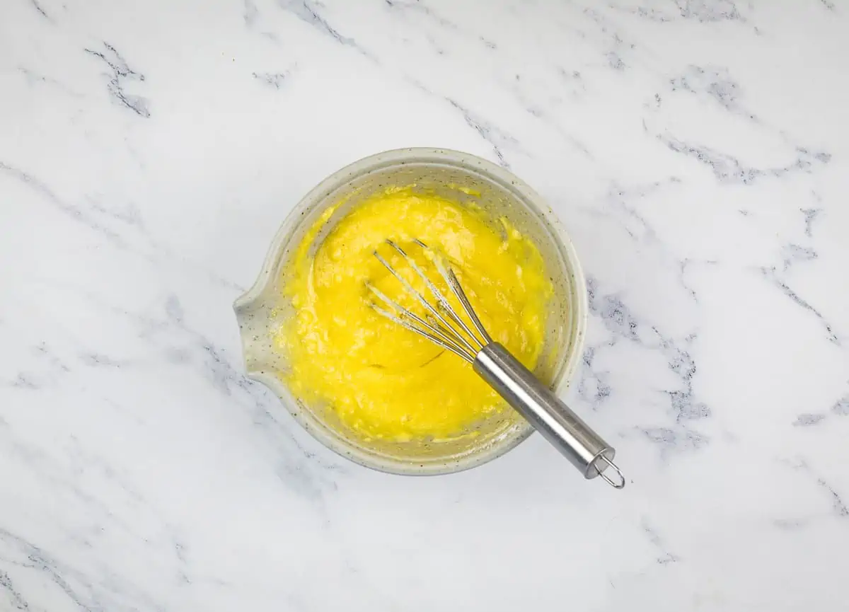 Dry ingredients added to the batter in a bowl.