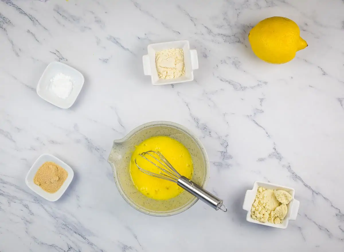 Mixing wet ingredients to make keto lemon mug cake.