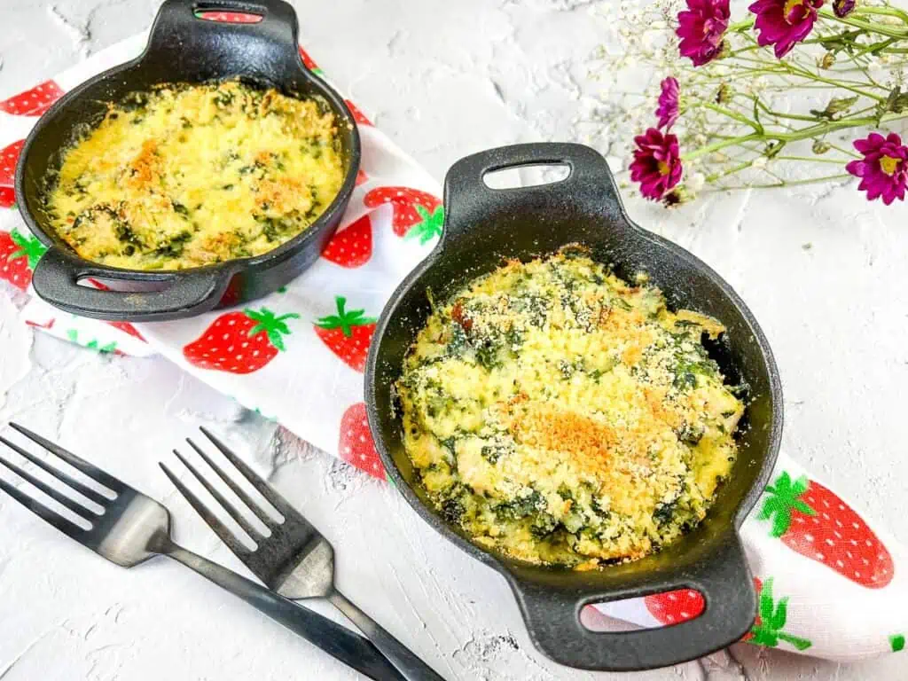 A horizontal image of 2 baking dishes filled with keto chicken florentine bake.