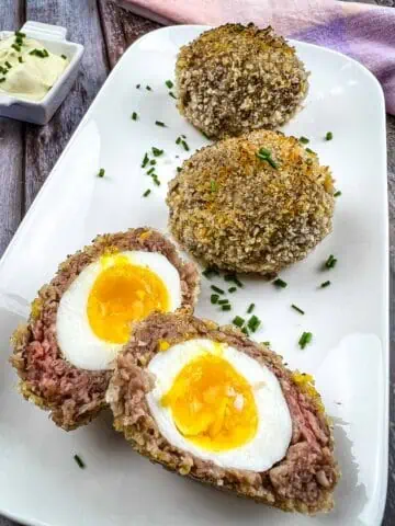 Keto Scotch Eggs on a white plate.