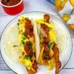 Low-Carb Breakfast Tacos on a plate with salsa nearby.