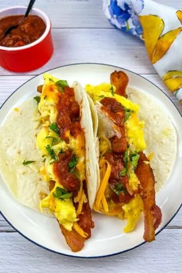 Low-Carb Breakfast Tacos on a plate with salsa nearby.