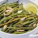 A bowl of Roasted Green Beans with Almonds and Lemon.