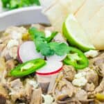 A white bowl filled with Slow Cooker Pork Chile Verde.