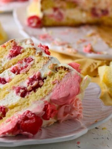 Delicious keto-friendly raspberry lemon cake with whipped cream, perfect for low-carb desserts.