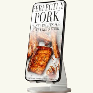 A phone on a stand with a Perfectly Pork eBook displayed on the screen.