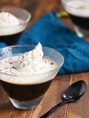 Three glasses of keto coffee jelly on a wooden surface.