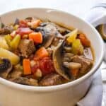 Beef Pot Roast Soup served in a white bowl.