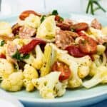 A plate of Keto Antipasto Salad beside a spoon.