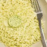 A plate of Cauliflower rice with a fork beside.
