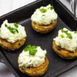 Green Goddess Stuffed Mushrooms in a black dish.