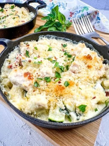 Keto chicken casserole with cauliflower and cheese in a skillet.